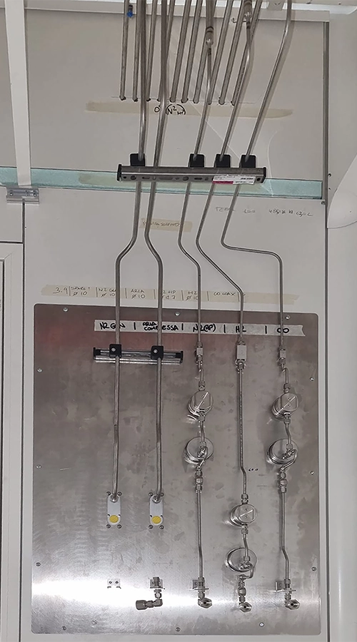 Piastra in acciaio inox con linee di distribuzione e valvole per gas tecnici.